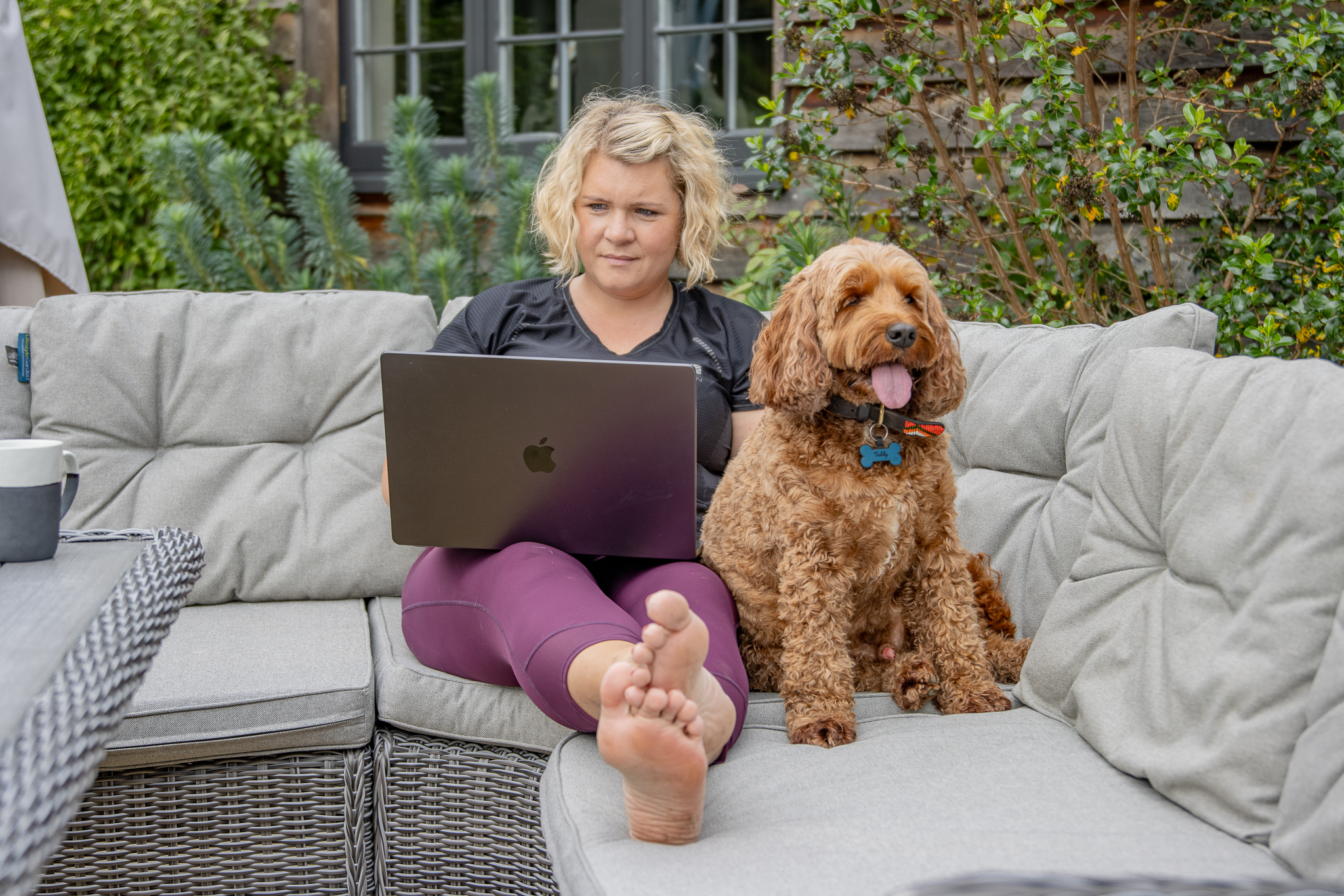 kate professional dog listener at work with her dog and a laptop